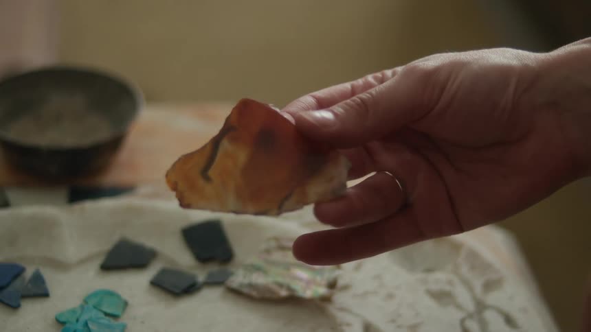 People examine different color chips on the plate