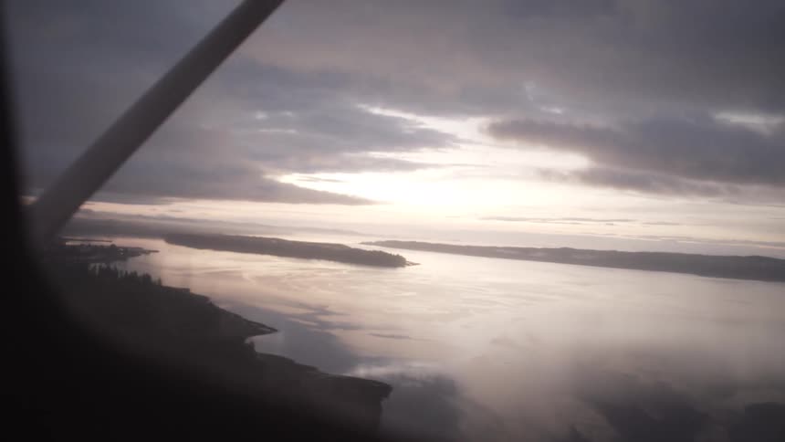 Seascape seen through the window of an airplane in midflight