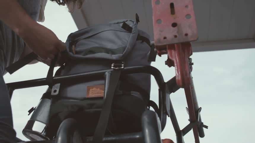 A person opening a backpack