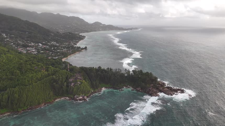 Aerial panorama of a seaside island with a city in the background