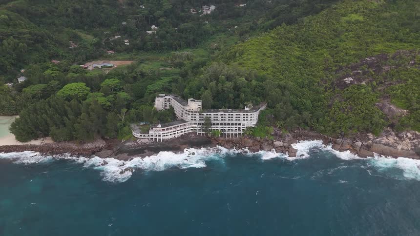 A large resort is on the edge of the tropical island