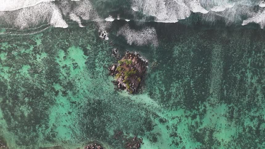 Isolated island in a turquoise blue ocean