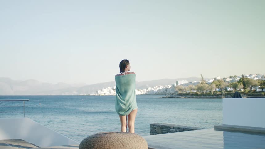 Woman in a towel in a seaside pool