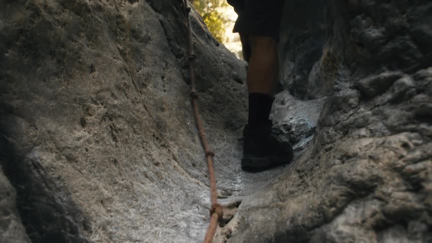 Person hiking between rocks