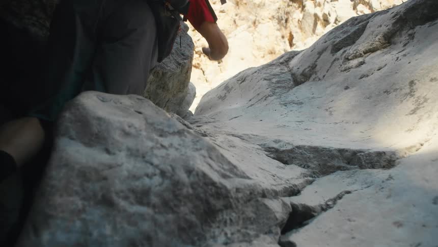 A man climbs up the rocks