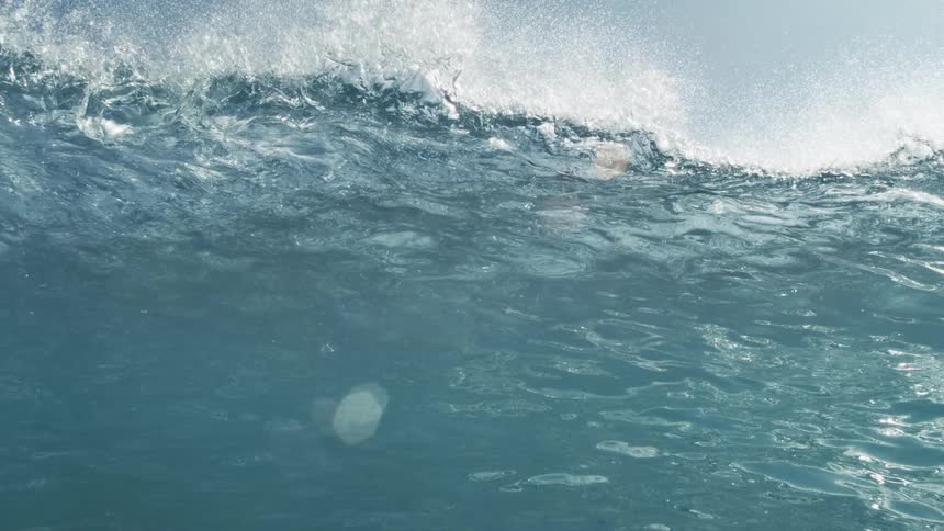 Ocean wave breaking close up in slow motion