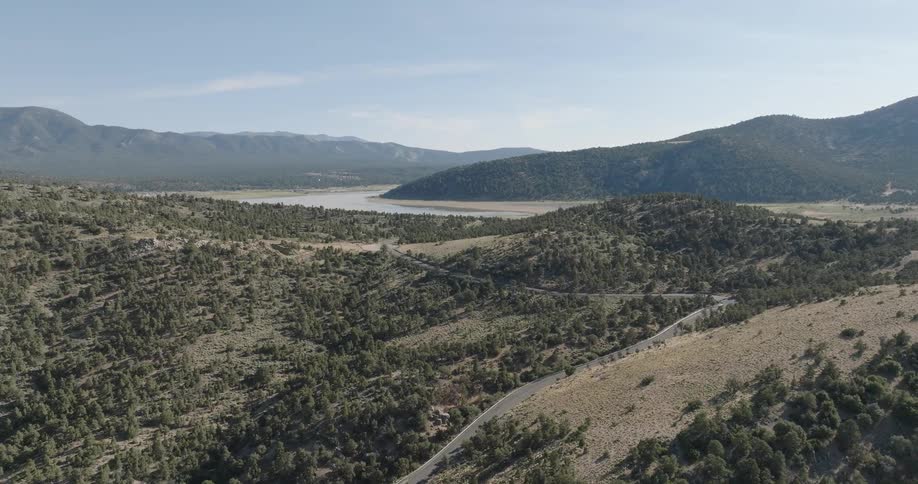 The river runs between the green hills
