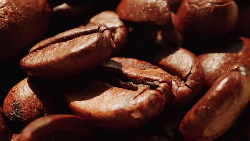 Coffee beans are set out to dry under the sun