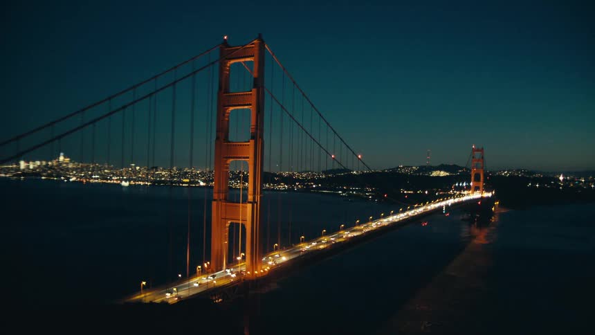 Bridge over the sea at night with vehicle traffic