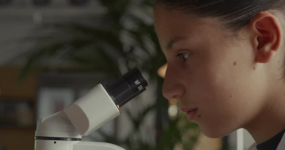 Woman looking into a microscope