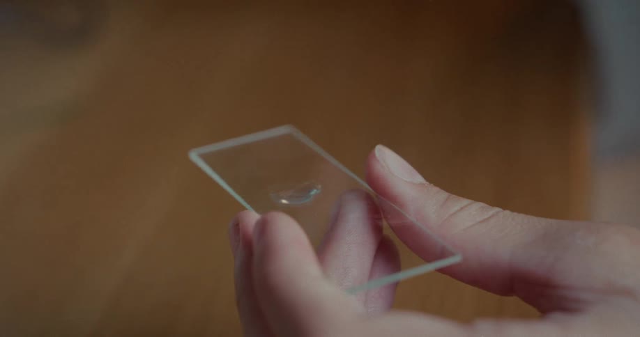 Liquid being poured into a small laboratory glass dish