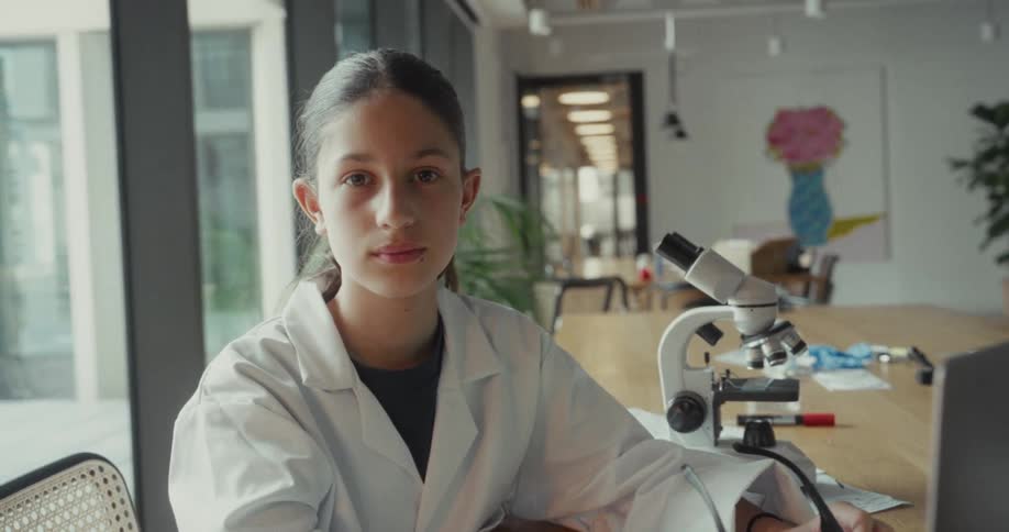 A girl is holding her glasses at the table