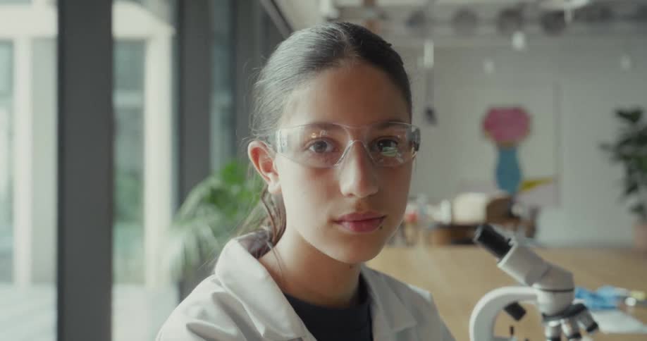 Teenager putting on lab goggles