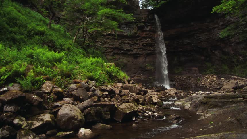 High waterfall on a mountain with vegetation