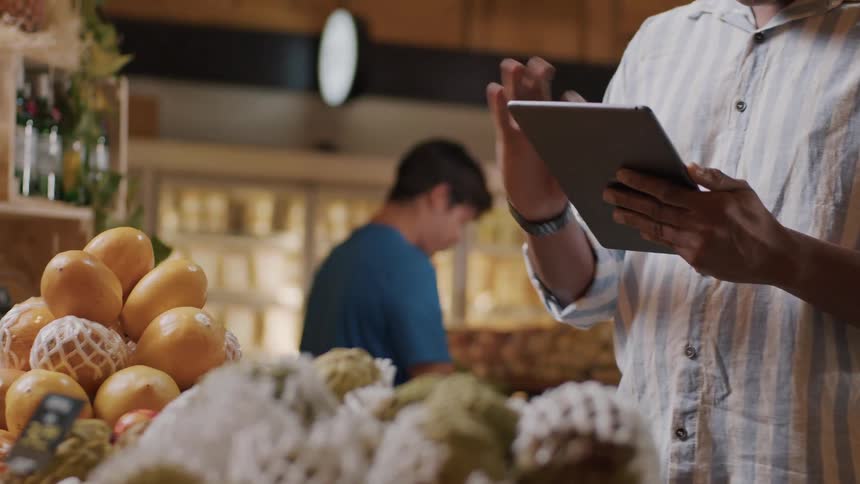 Customers shop while an employee takes inventory