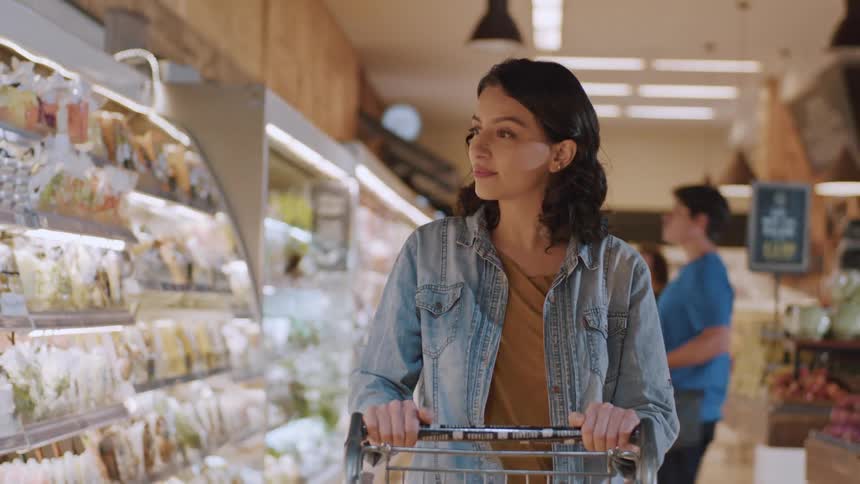 Customers move through a grocery store shopping