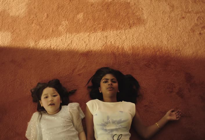 Two girls lie down panting while resting after exertion
