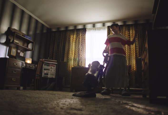 The child is dancing as they vacuum