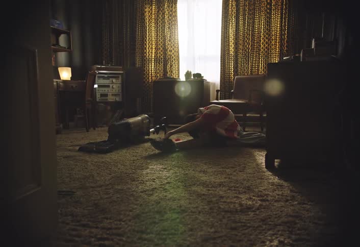 The child is stretching on the carpet