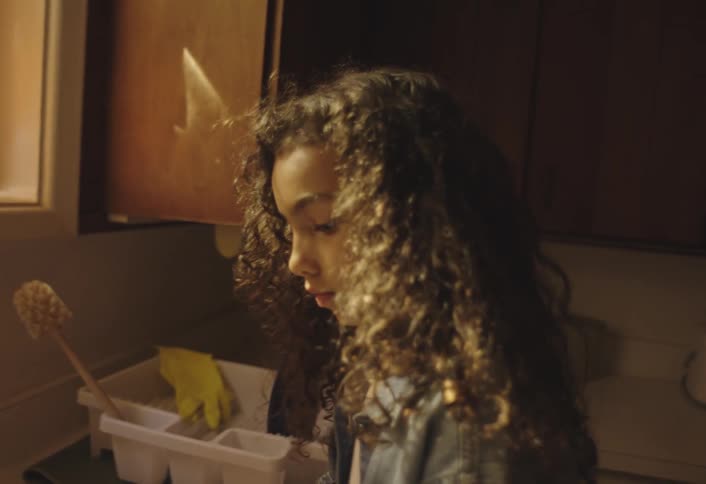 Child with gloves washing dishes