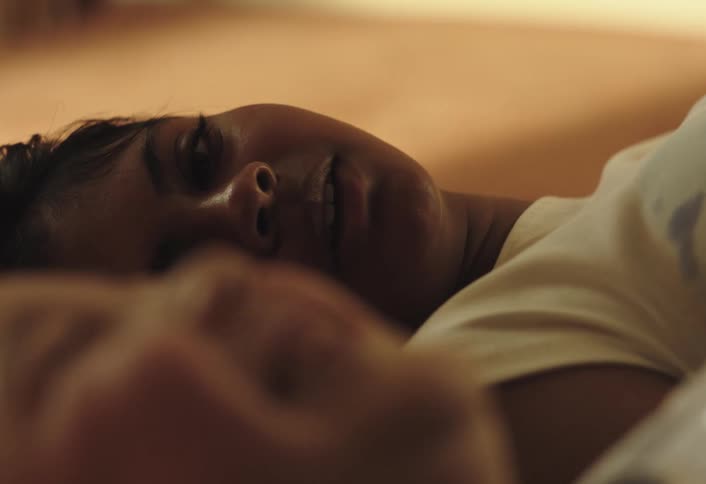 Two girls lying down talking and smiling