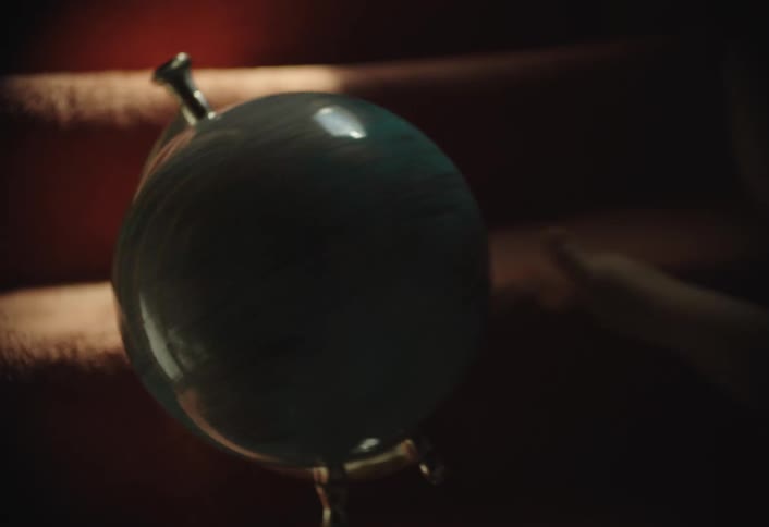 The child is spinning the globe on the stairs