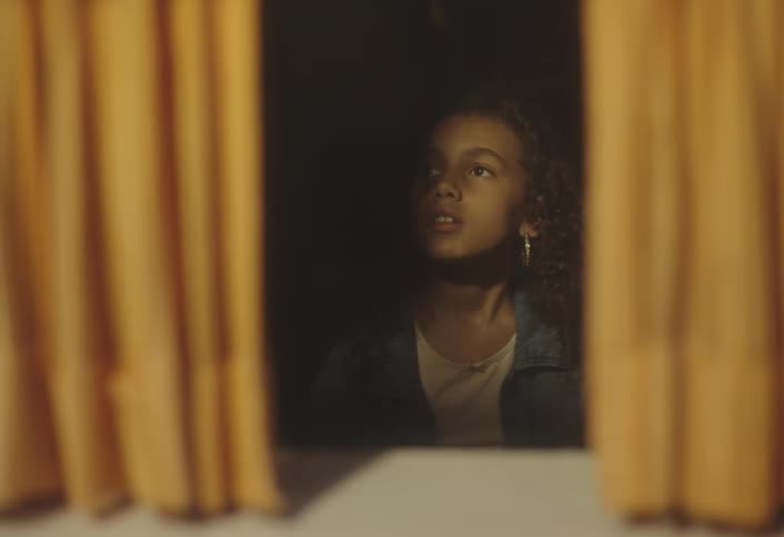 Girl facing a window watching