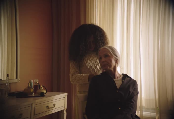 Girl combing a ladys hair