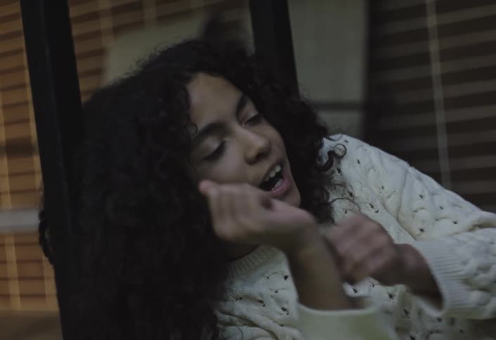 Two curly haired girls talking to each other