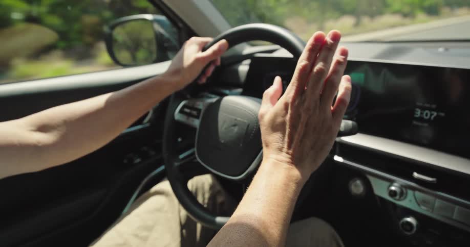 Cheerful man driving a car