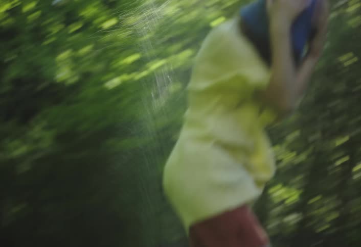 Child having fun in a backyard with water being splashed