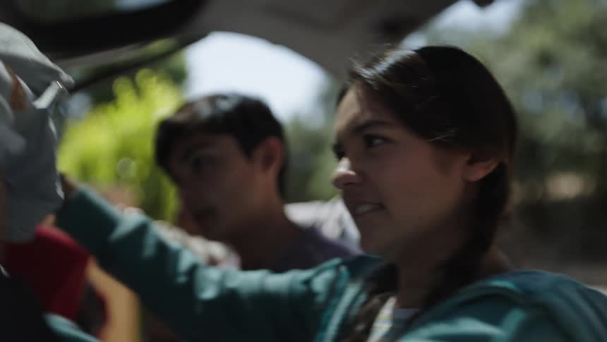 A family pack the car tight with luggage before going on a road trip