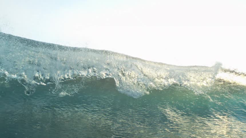 Crystal clear ocean wave breaking