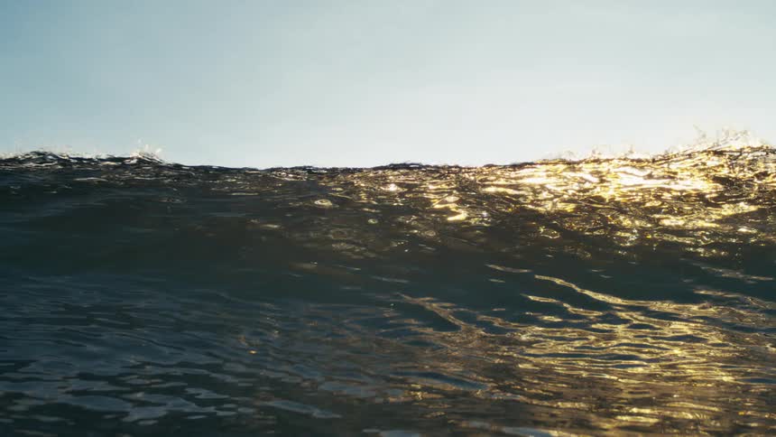 Huge wave forms and crashes across the ocean surface during daytime