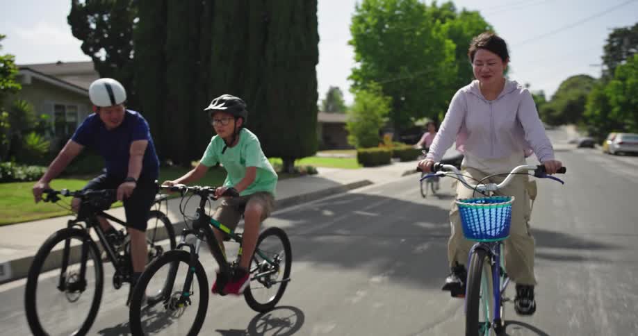 Family riding bikes in a suburb