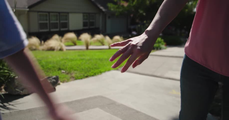 Two people walking and holding hands