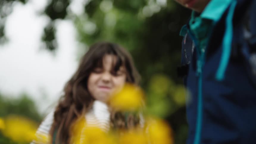 Children are smelling flowers together