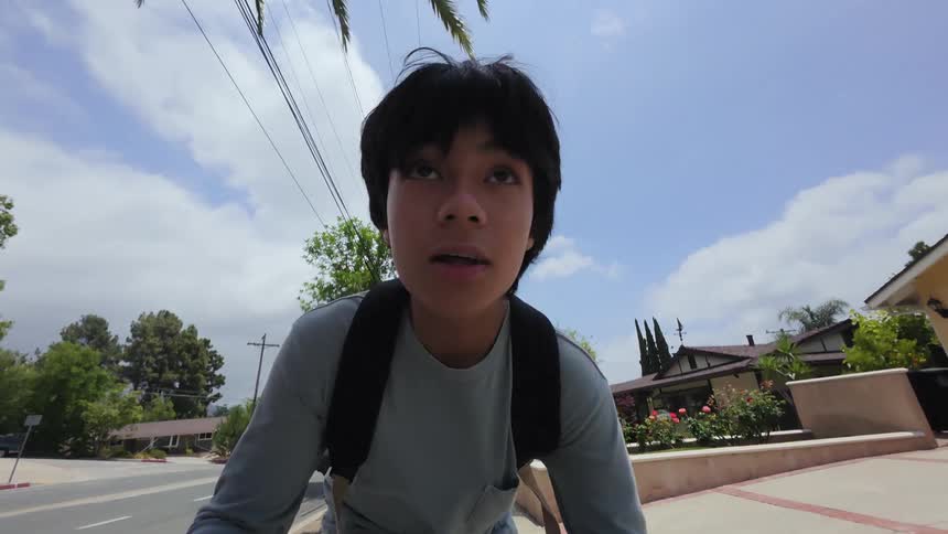 A boy is skating past the homes in town