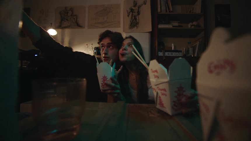 A couple take a selfie while eating food