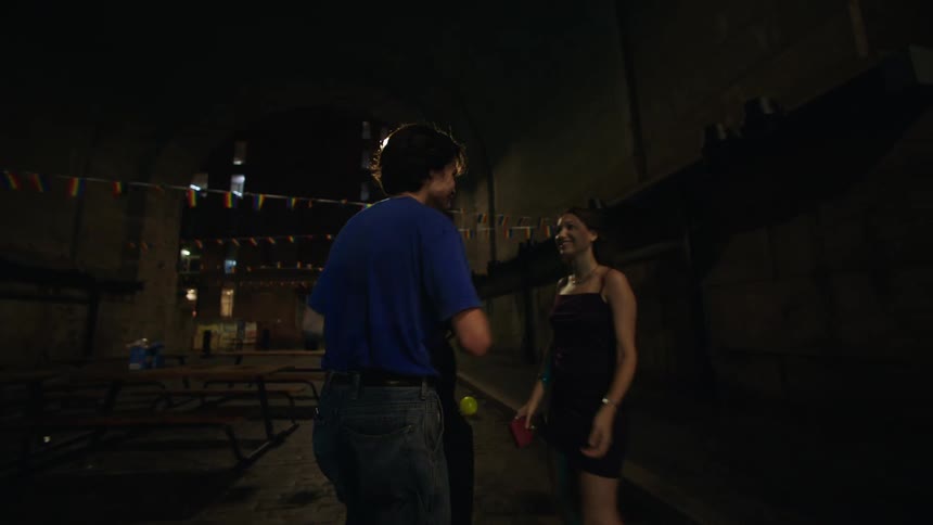 A couple walk and talk at night