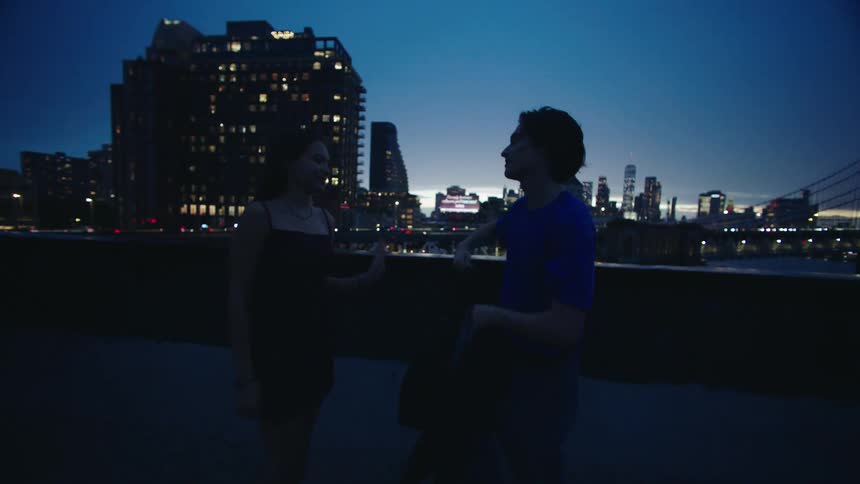 A couple dances on a rooftop