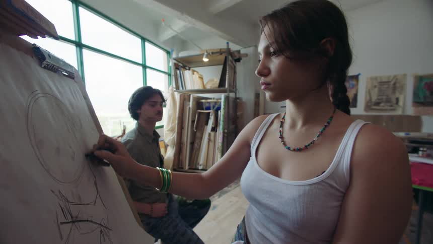 Woman drawing and a man beside her