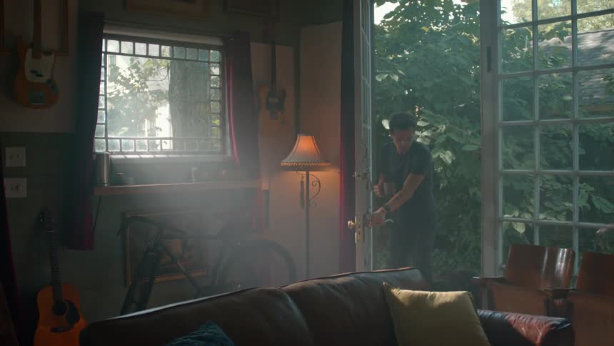 Man entering the house with a dog
