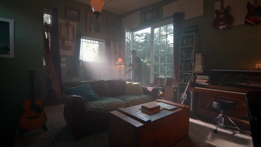 A woman enters her house with her dog who then walks around the living room