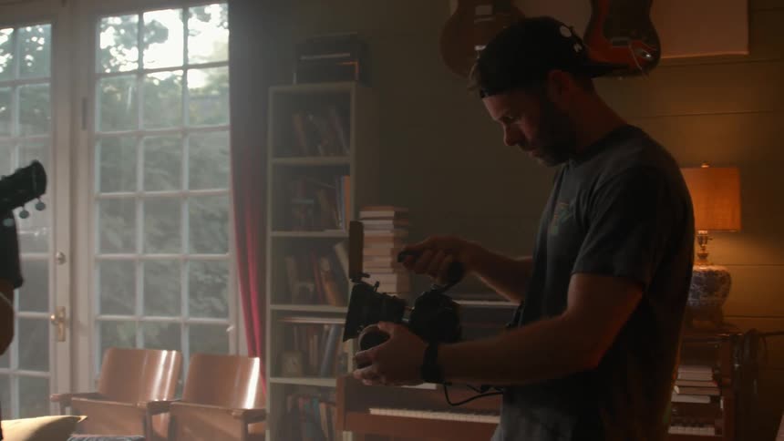 A man is being filmed while playing the guitar