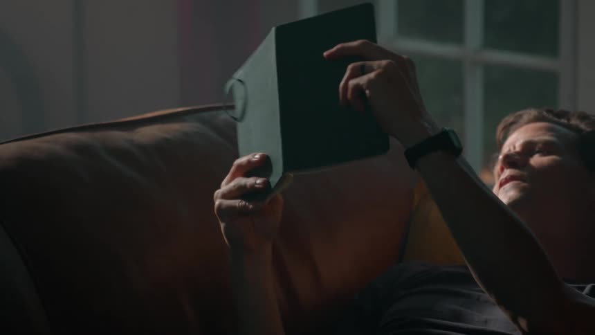 Man lying down reading a book