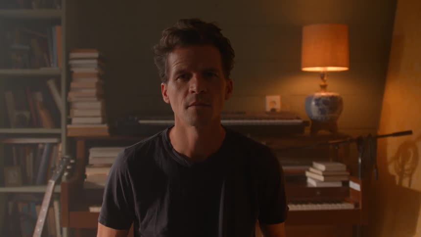 Man in an indoor space with a neutral expression