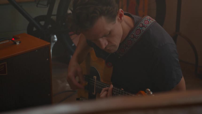 Man sitting playing a guitar