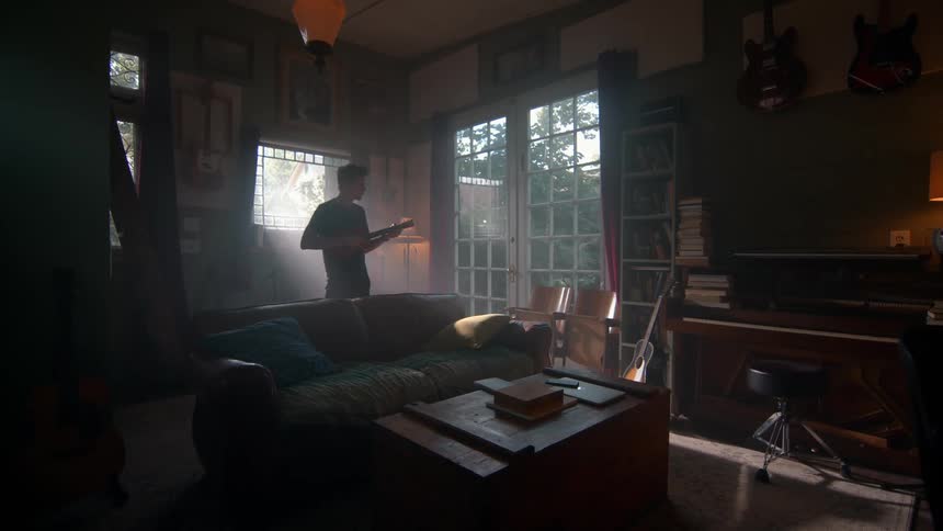 Man playing guitar indoors