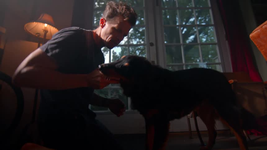 A man plays with his dog